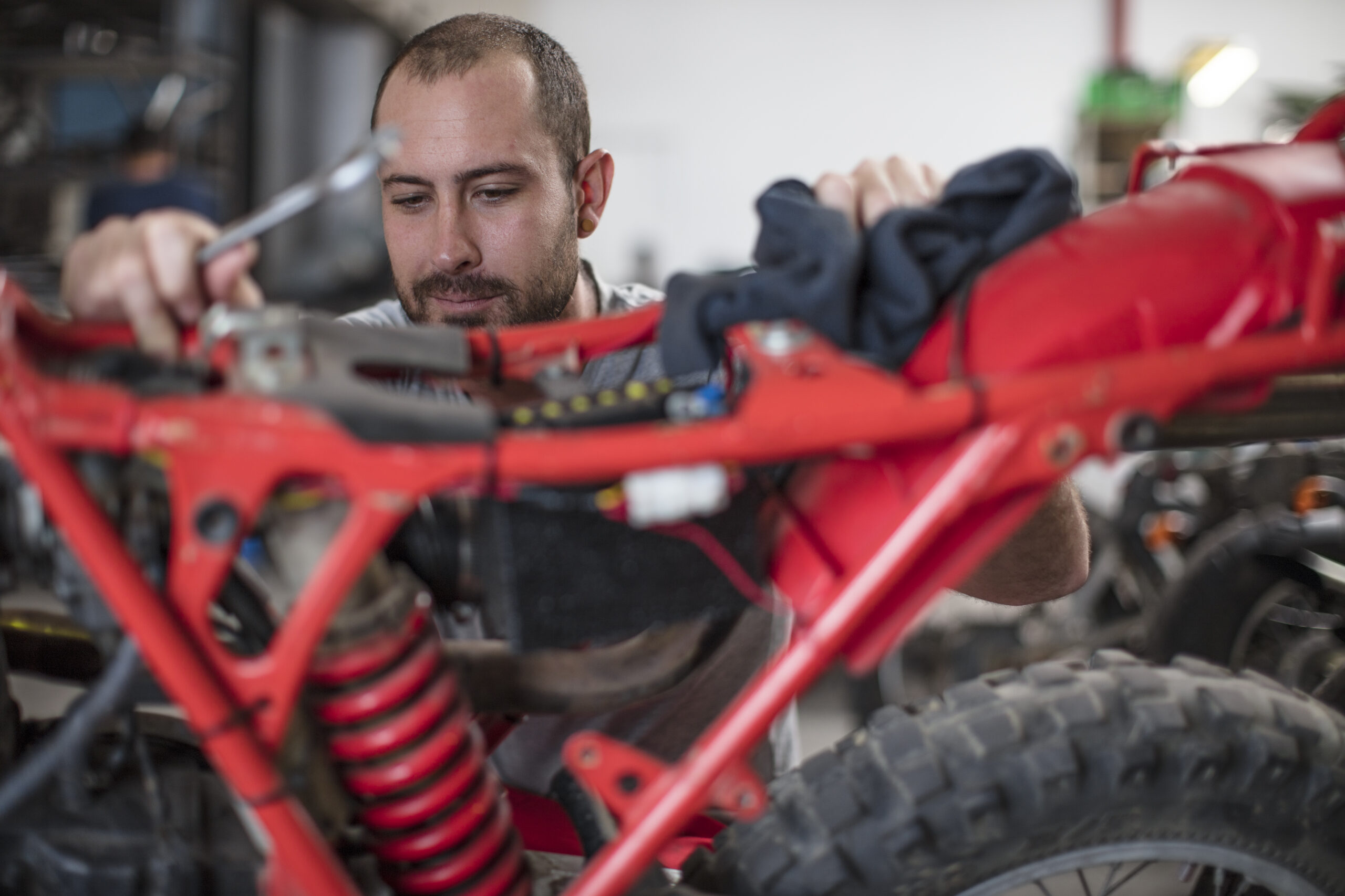 mechanic working on motorcycle in workshop 2023 11 27 04 57 37 utc scaled