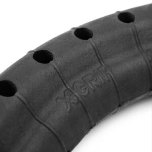 X-GRIP – Mousse Hard Enduro RaceReady EXTREME-2 140/80-18 - Creations Mx Factory Close-up of a segmented rubber grip with circular holes and embossed lettering that reads 'EXGRIP' on a dark, textured surface.