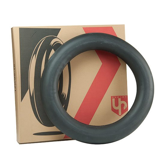 Dark gray tire ring resting against a beige cardboard box with a black wheel graphic and bold red diagonal stripe.